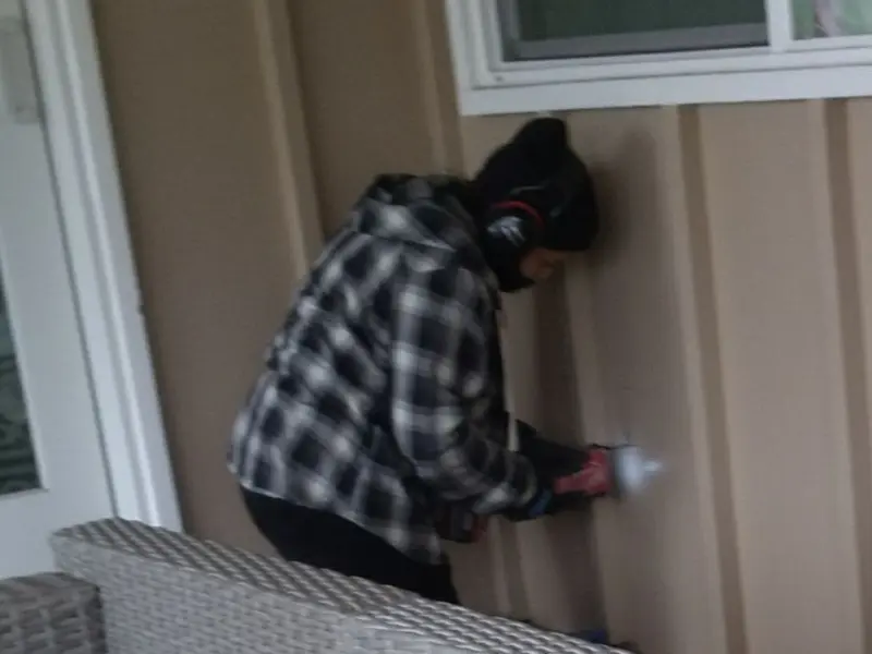 Professional electrician installing an exterior outlet in Schuyler