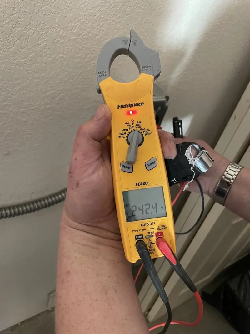 Voltage testing with clamp meter during Ceiling Fan Installation in Schuyler